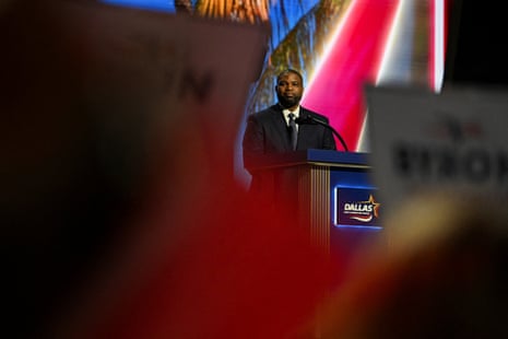 A man stands at a lectern