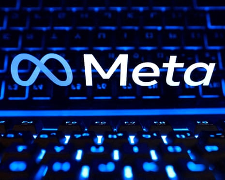A blue-lit keyboard glows beneath a screen showing the Meta logo and name