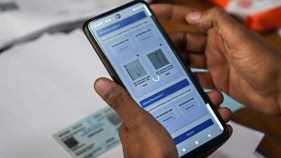 An enumerator uploads documents of an applicant registering for the Draft Electoral Roll 2026 as part of the ECI's SIR. (AFP)