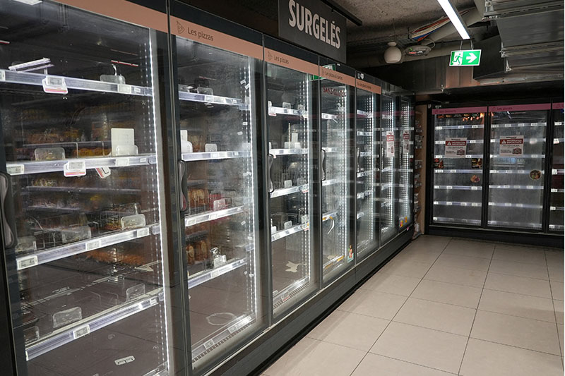 View of empty refrigerators at the frozen food aisle inside an Intermarche supermarket in Paris the day after a cyberattack targeted refrigeration systems at French supermarket chains, causing food losses and fires at several stores, France, October 13, 2026. (Reuters/Lucien Libert)