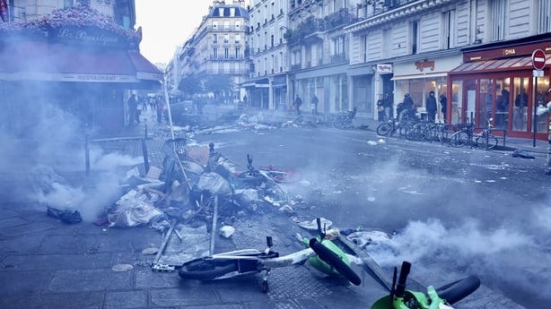 Firefighters extinguish fires set to bicycles and street debris