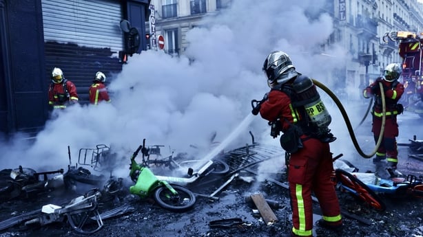 Firefighters extinguish fires set to bicycles and street debris