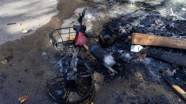 a electric bike on the ground set on fire